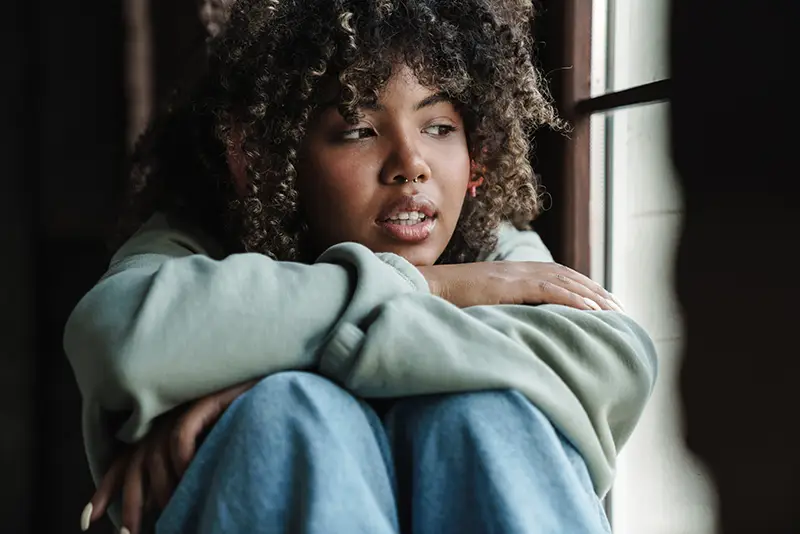 African-American woman staring out the window